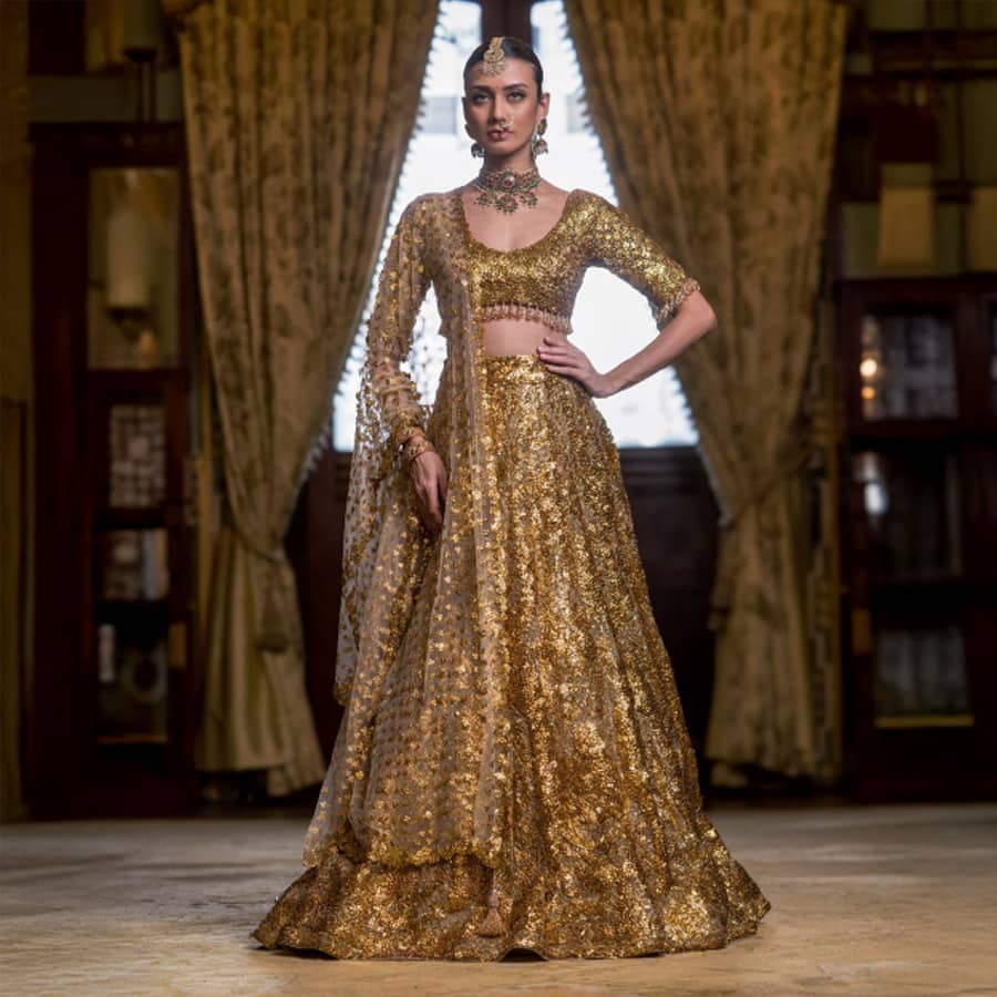 Rouen Golden Lehenga Set With A Cropped Blouse Adorned With Sequins