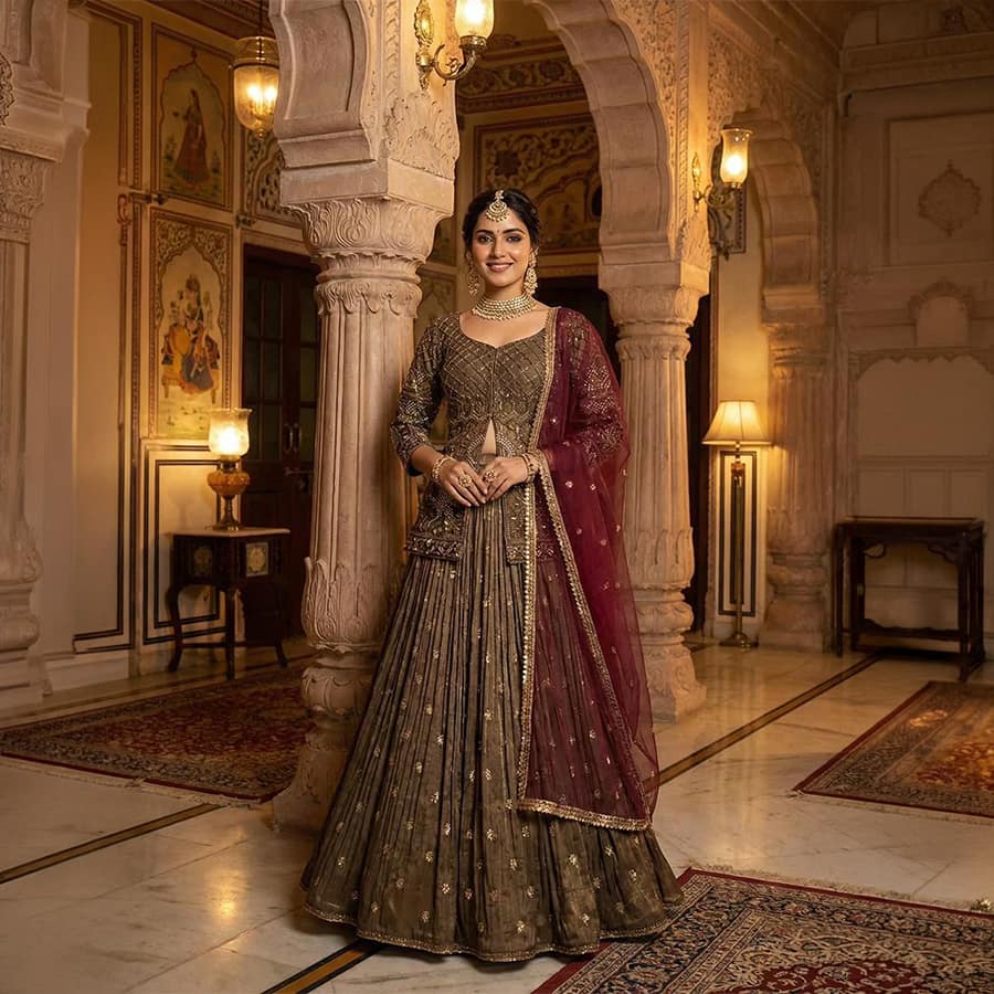 A stunning olive-golden jacket lehenga set featuring a beautifully flared lehenga, stylish blouse, and embroidered long jacket