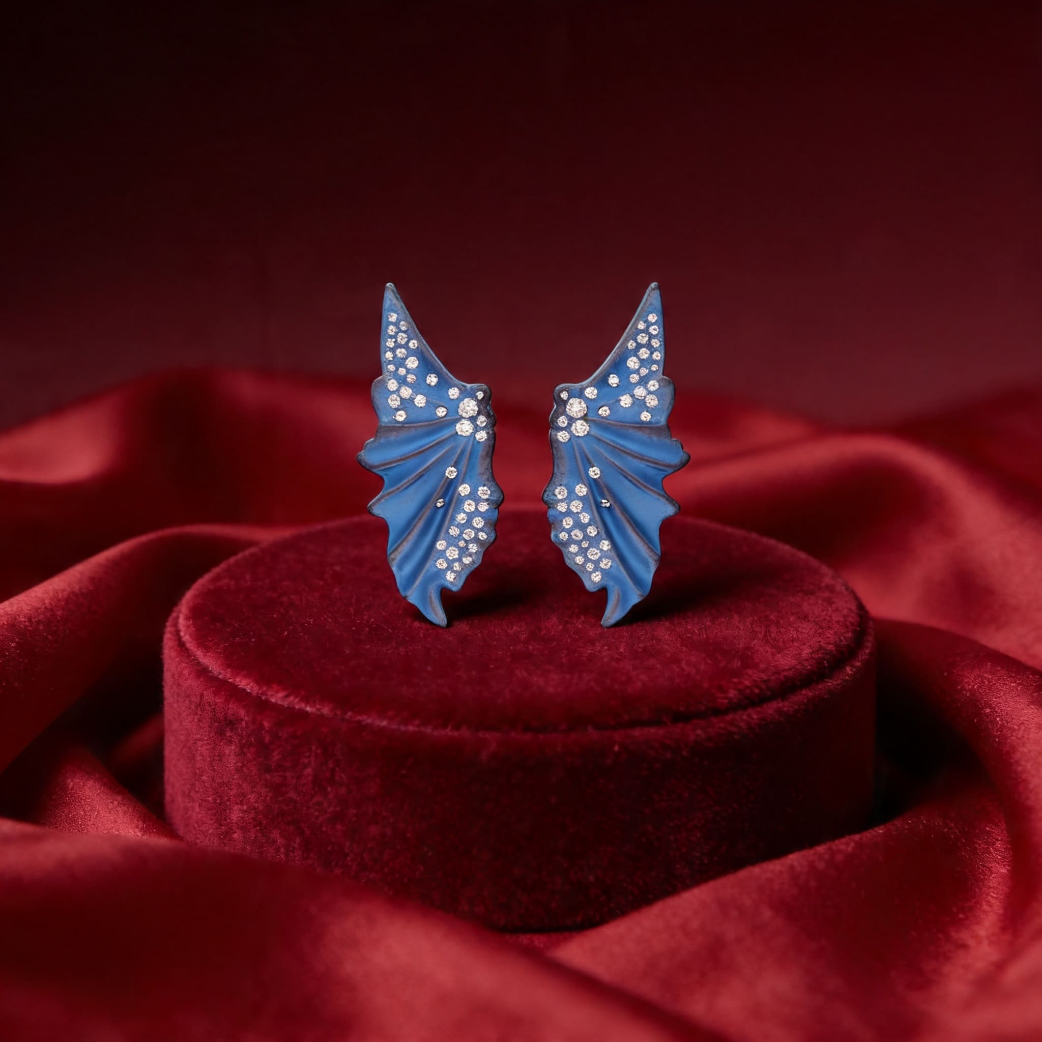 Titanium ear studs featuring butterfly wing designs with diamonds