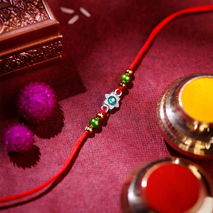 Silver Rakhi - Delicate Green Stone Floral Design