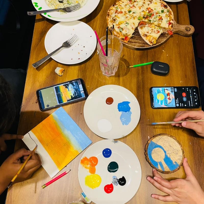 Art supplies and a shared table at The Coffee Palette