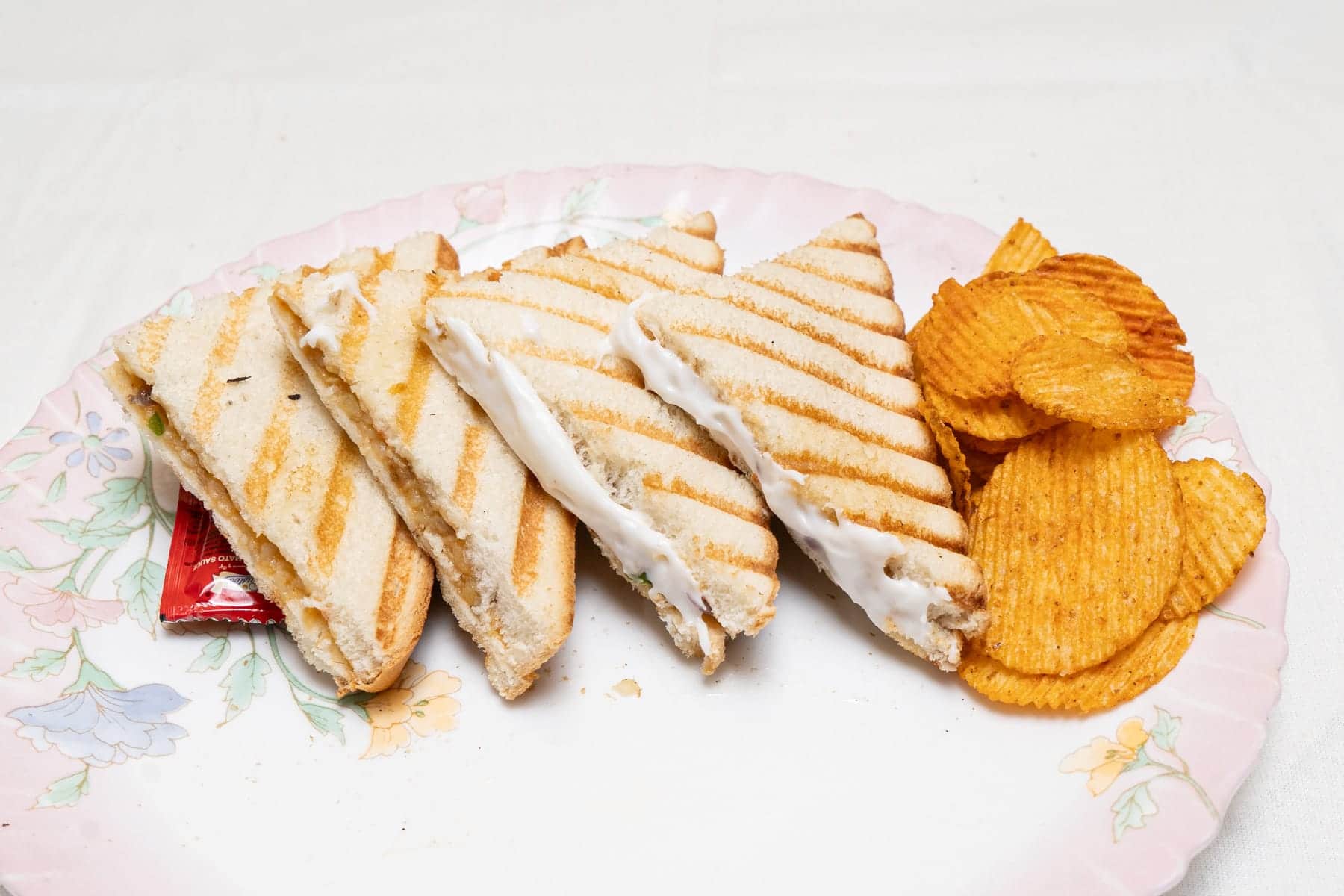 Grilled sandwich with chips at Chéri Cafe